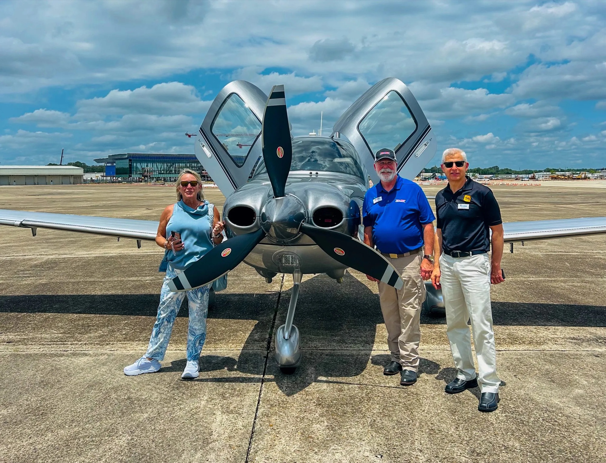 Pilots beside a Cirrus SR22 on the ramp at Continental's 120th anniversary demo flights